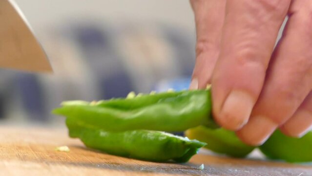 Cutting jalapenos in the kitchen preparing the dinner