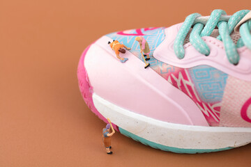 Miniature creative cleaner is brushing shoes