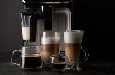 Group of cup with different freshly types of coffee: cappuccino, latte and espresso.