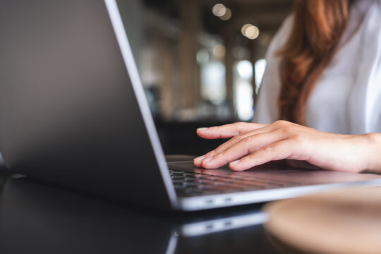 Closeup image of a hand touching on laptop computer touchpad