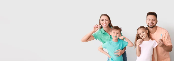 Wandcirkels Tandarts Portrait of happy family brushing teeth on light background with space for text  © Pixel-Shot