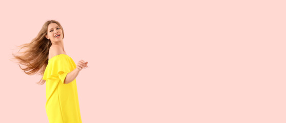 Beautiful young woman dancing against pink background with space for text