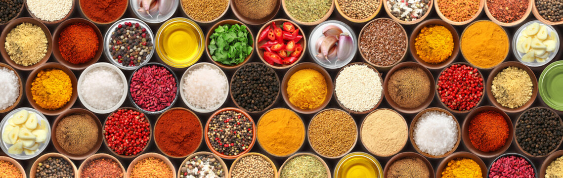 Set of bowls with different spices and herbs, top view