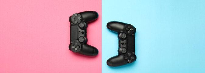 Modern game pads on color background