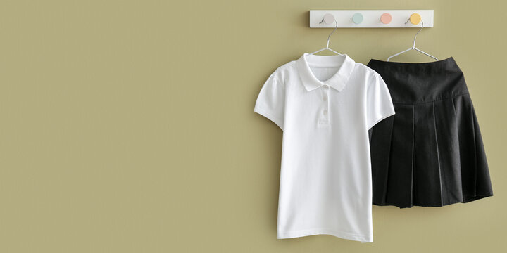 Stylish School Uniform Hanging On Color Wall. Banner For Design