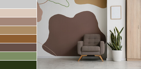 Armchair and houseplant near wall in living room. Different color patterns