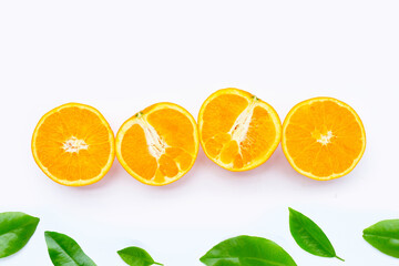 Orange fruit with green leaves on white background.