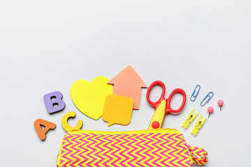 Pencil case and different stationery on white background