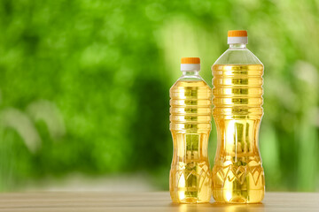 Bottles of sunflower oil on table outdoors