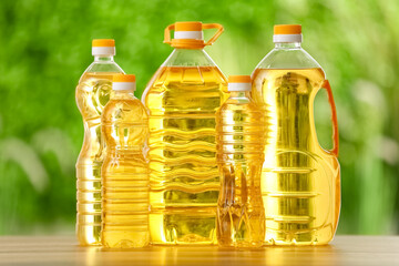 Bottles of sunflower oil on table outdoors