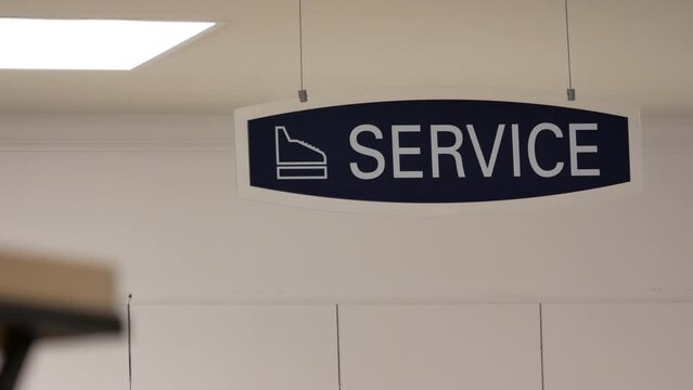 Motion of service sign hanging up the roof inside sears store with 4k resolution