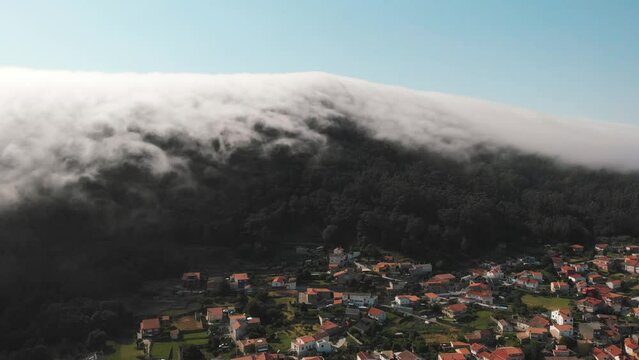 fairytale-like flight scene near a lenticular cloud formation near the village of Monte de Santa Tecla (Santa Tecla Mount) Galicia, Spain.  A popular tourist destination and Spanish cultural center.