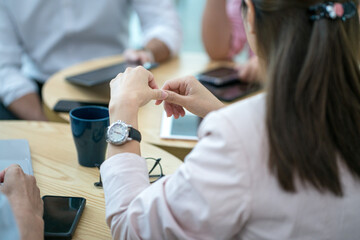 Business people having a meeting around a table.Close up view. Selected focus on woman executive's...