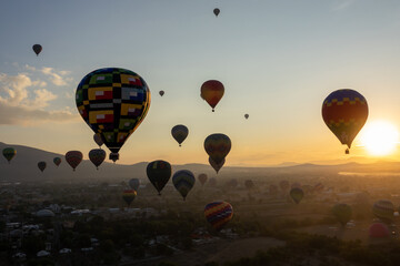 Colorful Hot Air Balloons Flying Over Ancient Pyramid of Teotihuacan, Mexico at sunrise -sunset,...