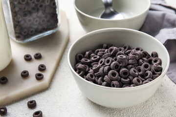Bowl of black cereal rings on table