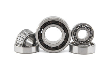 Group of various ball and roller bearings on white