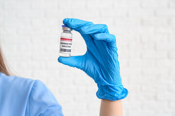 Female doctor with monkeypox vaccine on white background, closeup