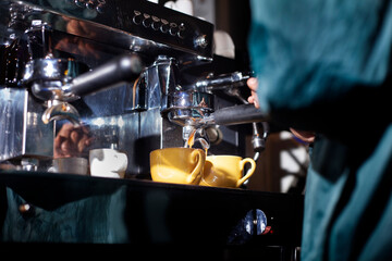 Making two cups of espresso with a coffee machine.