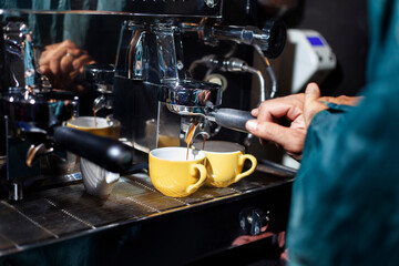 Making two cups of espresso with a coffee machine.