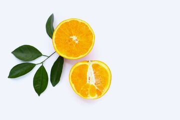 Orange fruit with green leaves on white background.