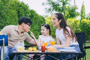 funny family outdoor party leisure activity parents with child cute lovely happy smile at backyard.