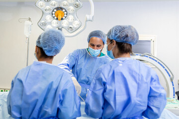 Medical team of surgeons in hospital doing minimal invasive surgical interventions. Surgery operating room with electrocautery equipment for cardiovascular emergency surgery center. - obrazy, fototapety, plakaty