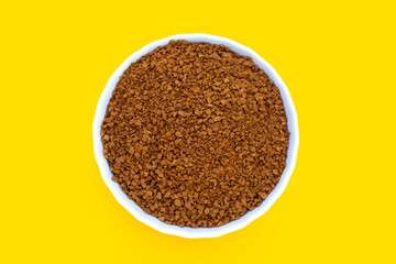 Instant coffee on yellow background.