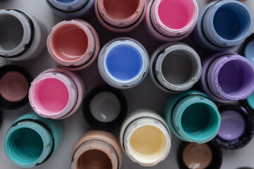 Many bottles of colorful paints staying open