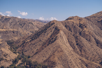 Armenia mountain gorge autumn view. Dry land mountain range a picturesque landscape view with blue sky. Stock photography.