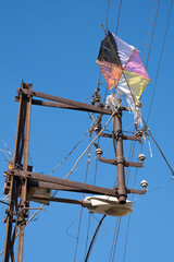 kite stuck on electrical wires. cable clutter.