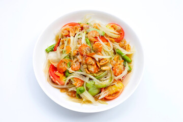 Dish of spicy papaya salad on white.