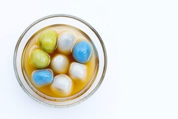 Black sesame dumpling in ginger tea recipes in glass bowl on white background.