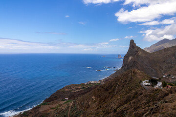 Scenic view of Atlantic Ocean coastline and Anaga mountain range on Tenerife, Canary Islands, Spain, Europe. Looking at Roque de las Animas crag and Roque en Medio. Hiking trail from Afur to Taganana