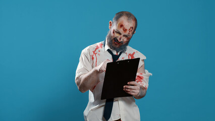 Heavy wounded scary zombie signing delivery documents on clipboard. Creepy mindless brain-eating...