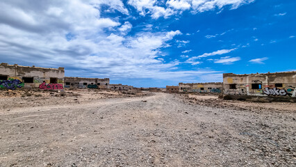 Obraz premium Panoramic view on the abandoned leper village of Sanatorio de Abona near Abades beach, east coast Tenerife Spain. Pueblo fantasma de Abades, an unnfinished project of leprosy hospital. Ghost town