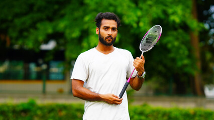 Portrait of badminton player holding badminton racket for stock
