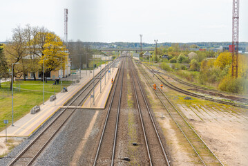 Fototapeta na wymiar empty multiple train tracks in summer with blue sky background.