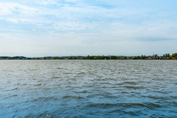 Beautiful summer panorama of Lithuania city Telsiai with cloudy sky, View over the lake Mastis to the city.