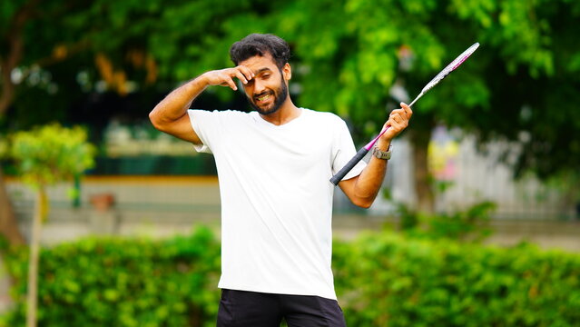 tired young man playing badminton image hd outdoor shoot