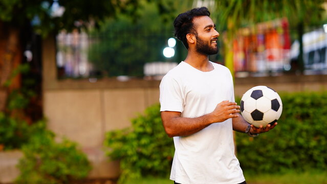 young bearded man with football