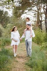 Pregnant woman with her family looking happy