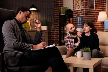 Young psychotherapist consulting people with relationship issues, trying to solve problems and give advice. Professional counseling about marriage and life difficulties, solution help.