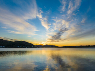 High cloud sunrise at the waterfront