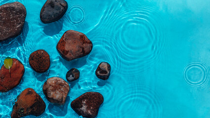 Naklejka premium Sea stones in the sea water. Pebbles under water. Stones In Blue Water - Zen Concept