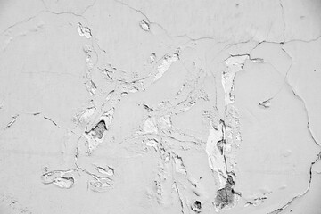 Old shabby white wall with cracks and scratches.