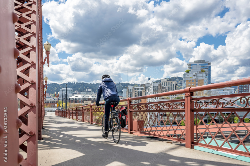 Wall mural cyclist amateur woman of athletic fit make a bike ride along the bike path on the bridge of the mode