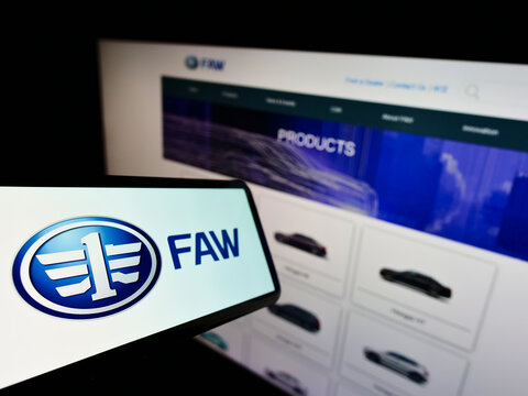 Stuttgart, Germany - 01-15-2022: Cellphone with logo of Chinese automotive company FAW Group Corporation on screen in front of business website. Focus on left of phone display.