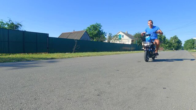 Man riding electric bike down the street