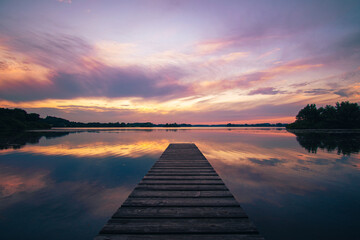 Colorful sunset over beautiful calm lake. High quality photo - 516705715