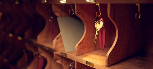 3D rendering, illustration of a hotel key hanging on a vintage cabinet or rack. - 516705755